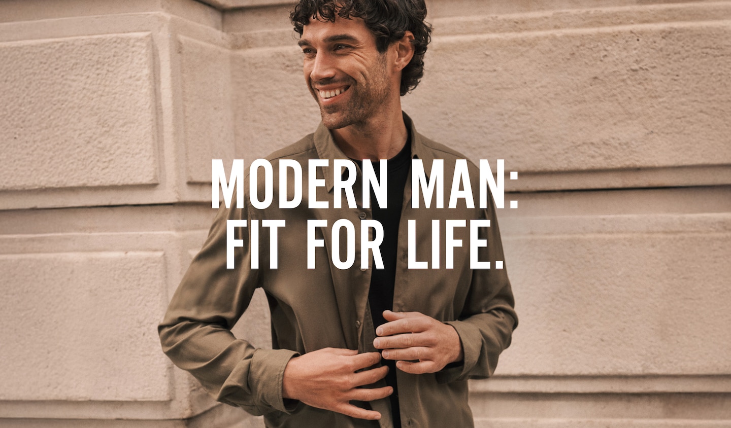 Modern Man: Fit for life. Model smiling wears a green shirt.