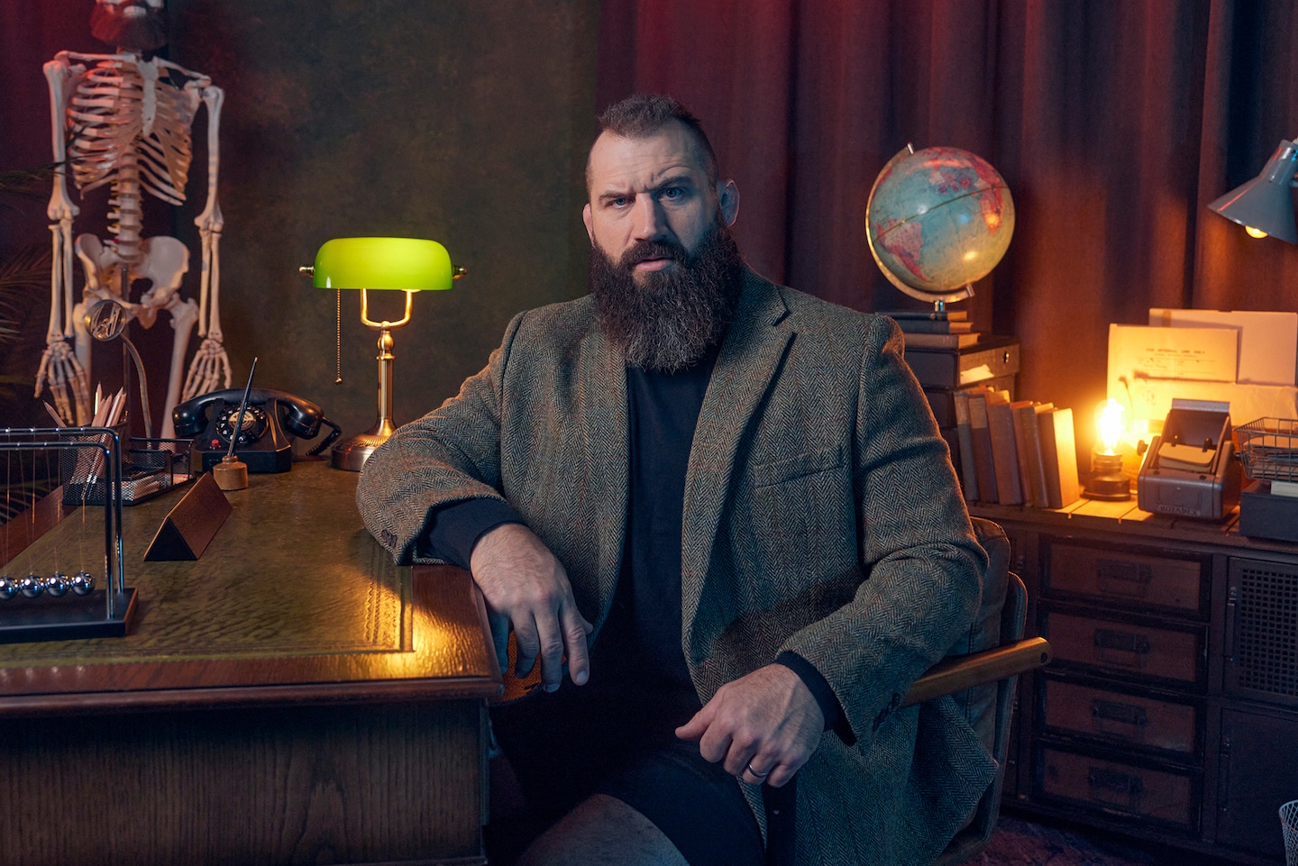Jacamo sponsor of Joe Marler Will See You Now. Joe Marler sat at desk in Tweed Blazer.