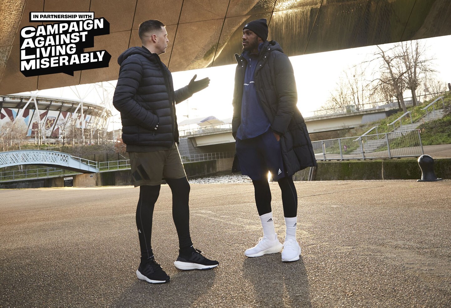 Mihail Antonio and Adam Smith stood chatting under a bridge