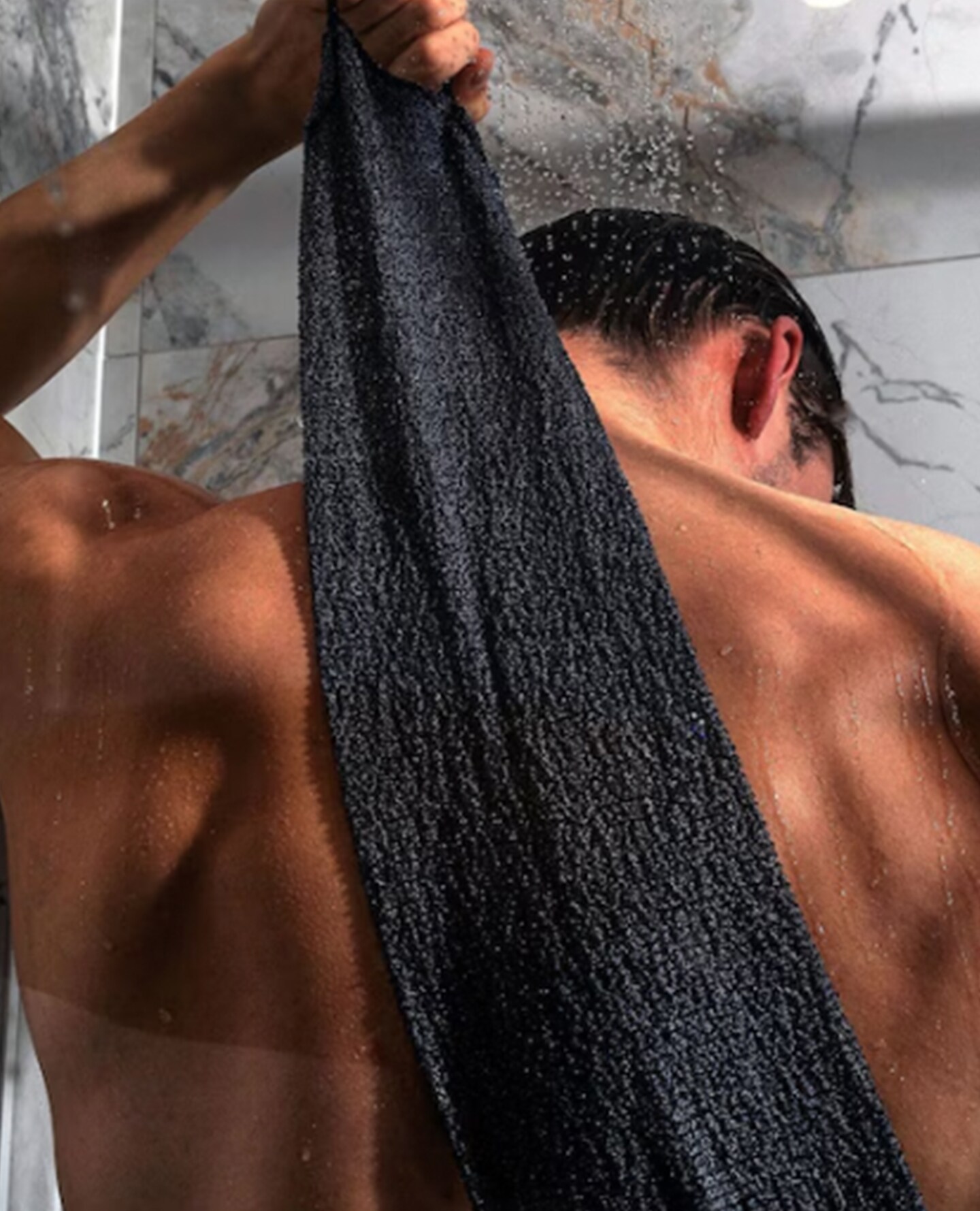 Model cleans back with towel
