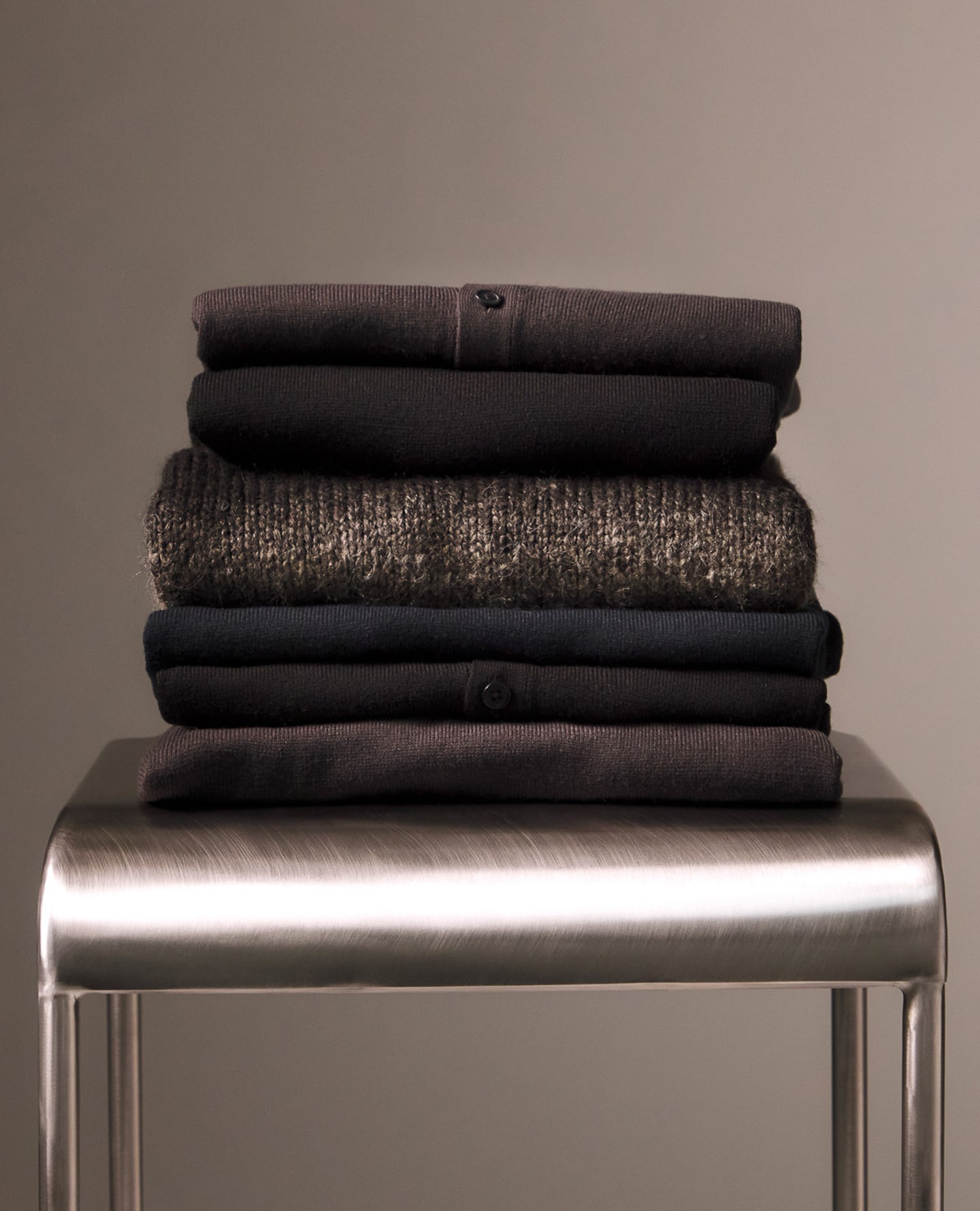 Folded Knitwear displayed on chrome chair, various types