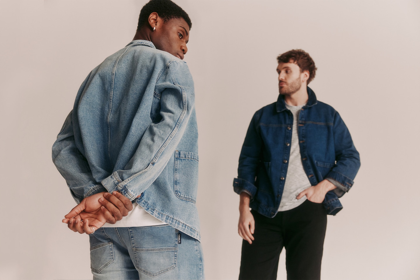 Two models wearing denim jackets and matching jeans