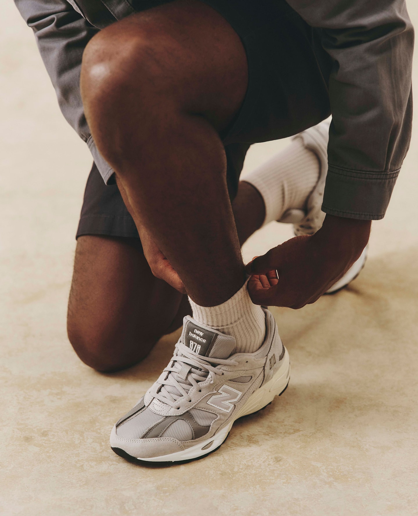 Model wears New Balance 878 Trainers