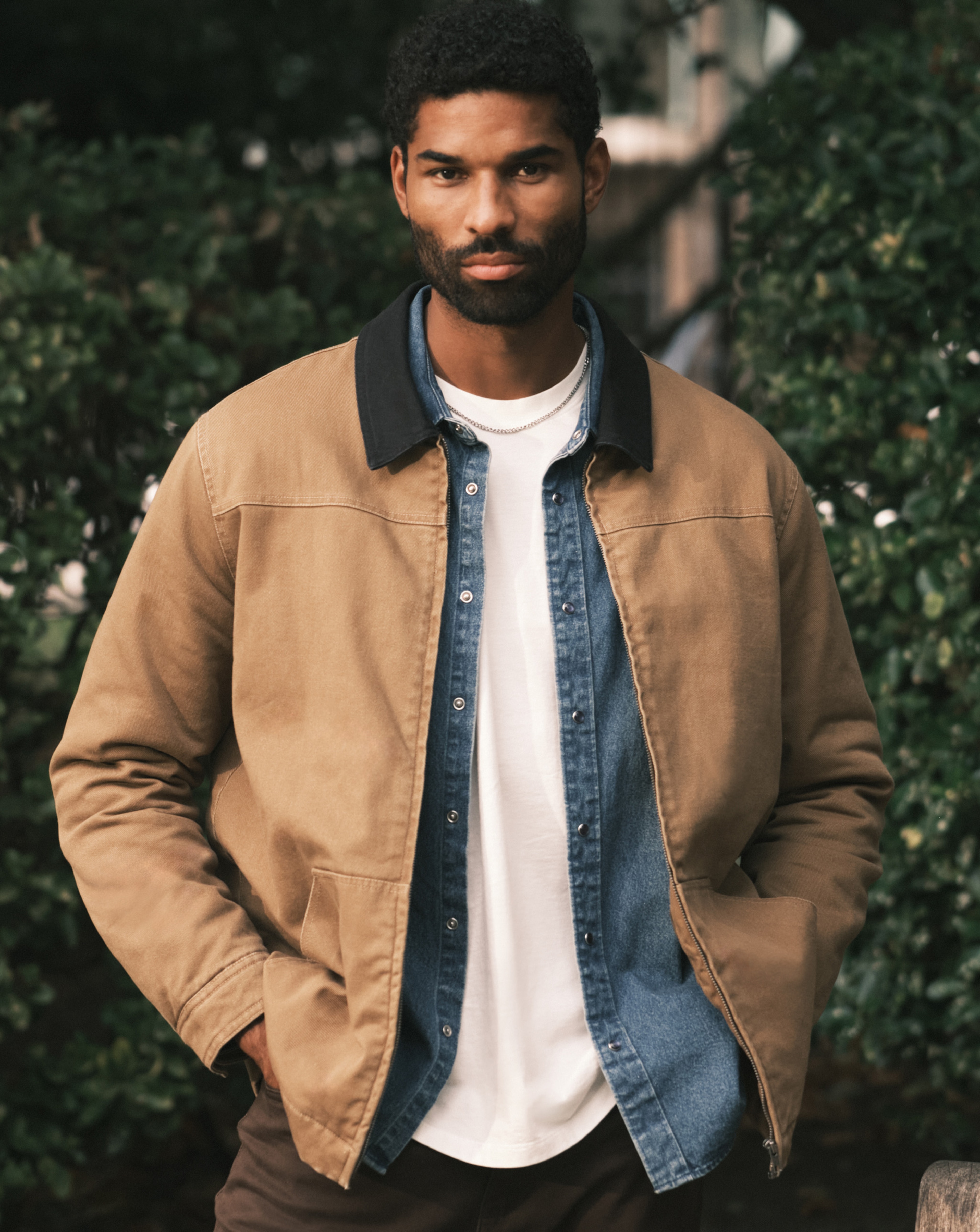 Model wearing a brown Union Jacket layered on top of a blue shirt and a white t-shirt