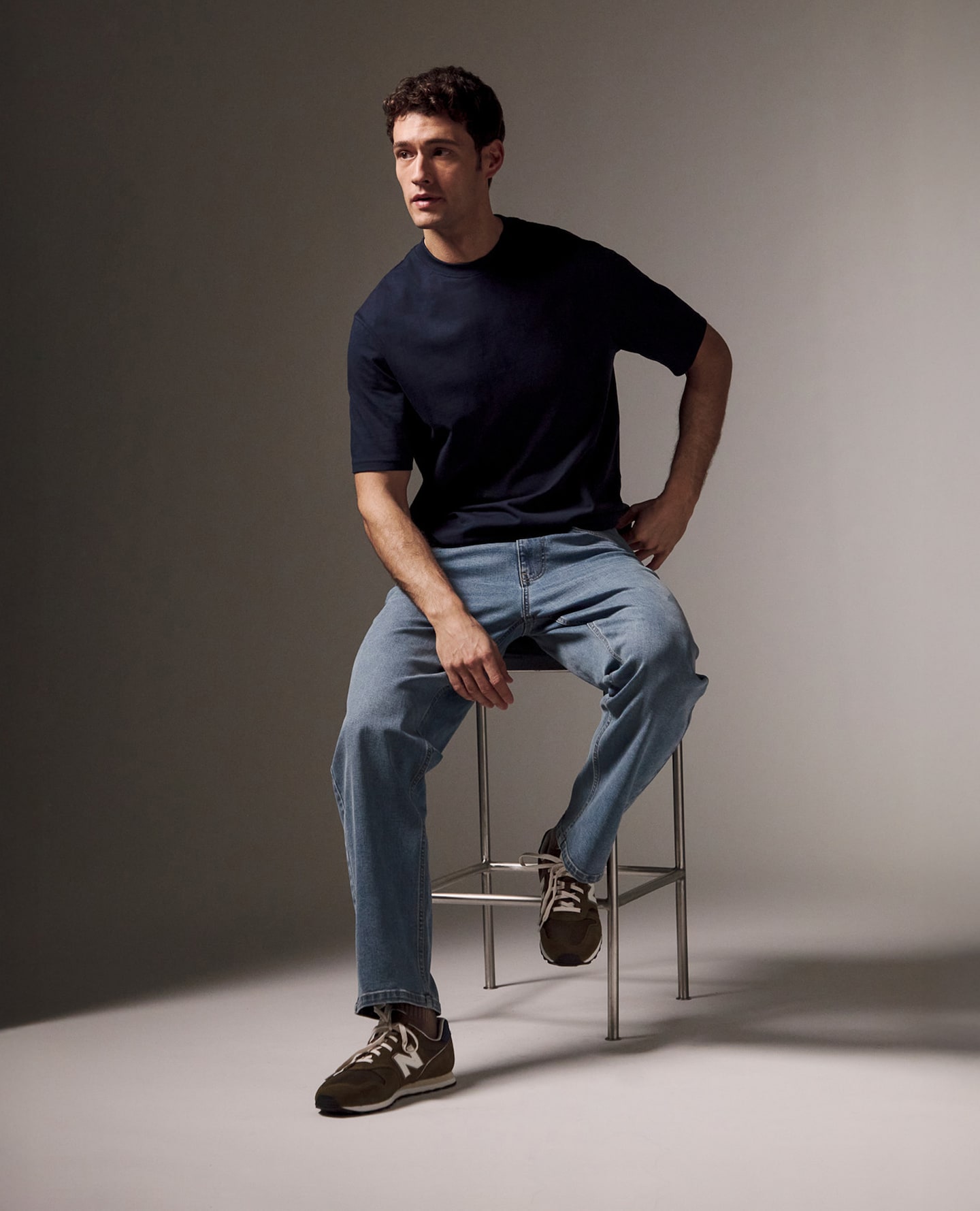 Model wears Navy tee with 100% Cotton Straight Fit Jean