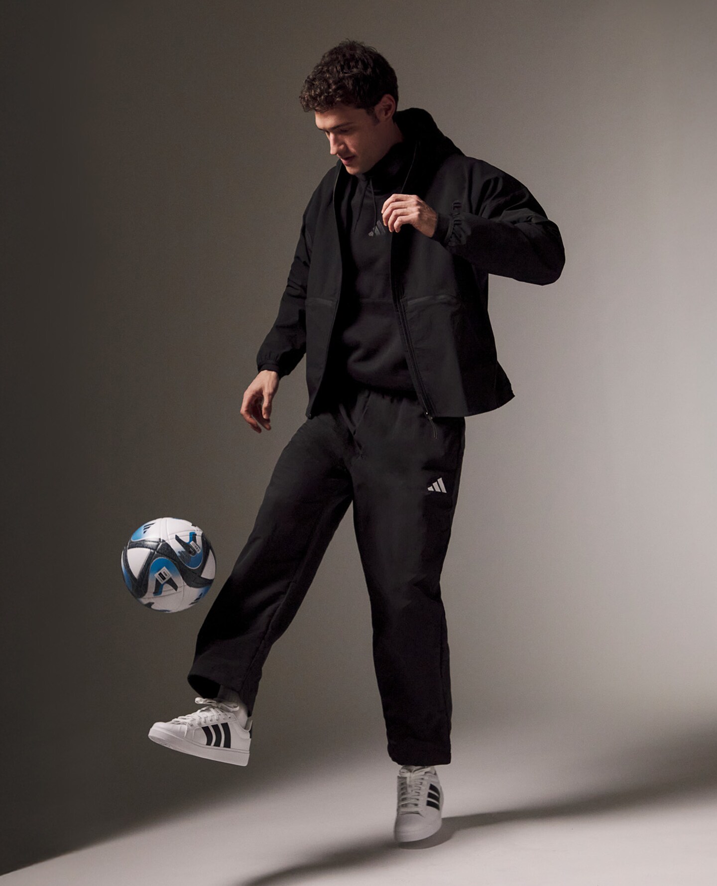 Model wears adidas Myshelter Wind Cheater Jacket with adidas 3 Stripes Full Zip Fleece tracksuit