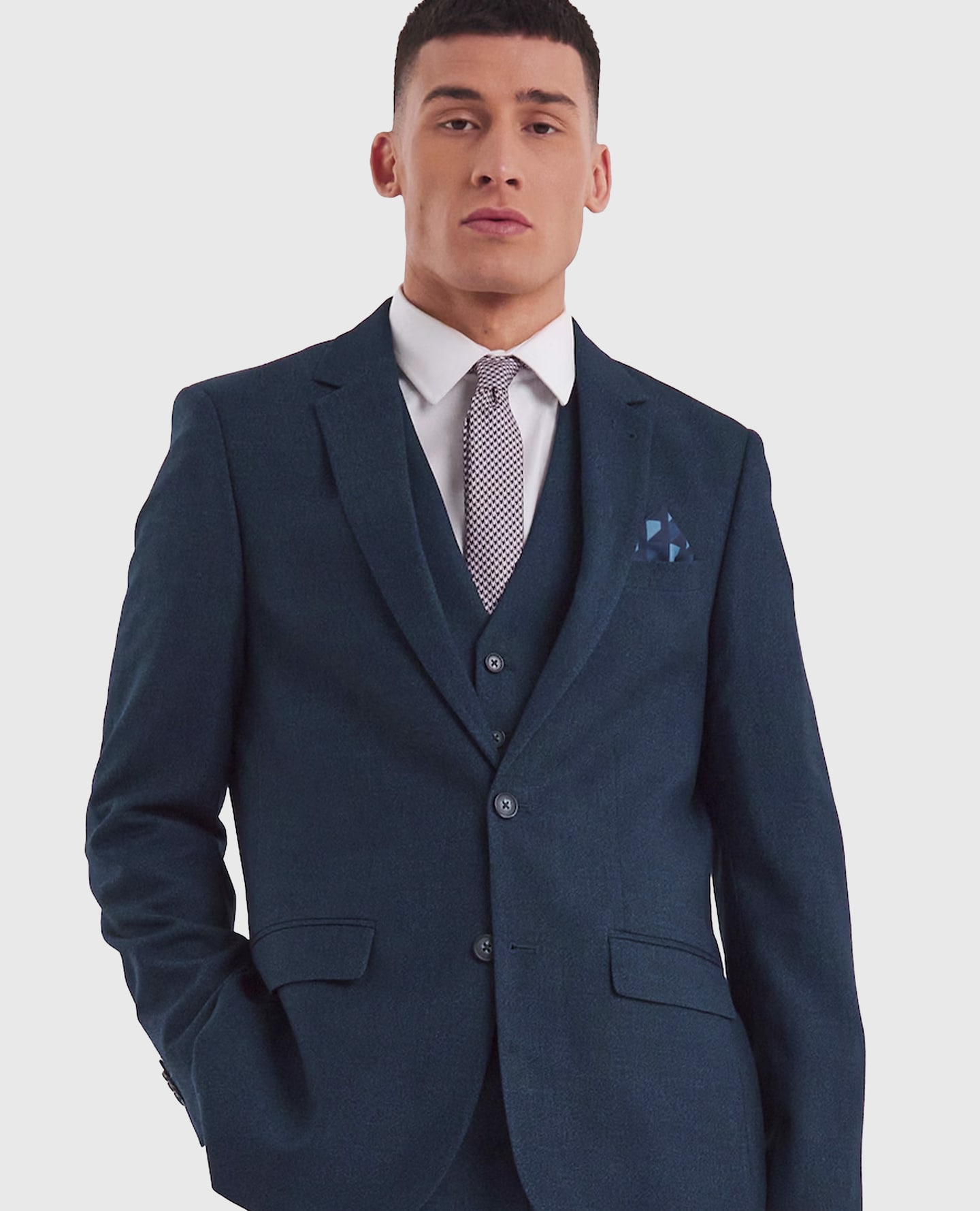 Model wearing three piece navy suit, purple tie and white shirt