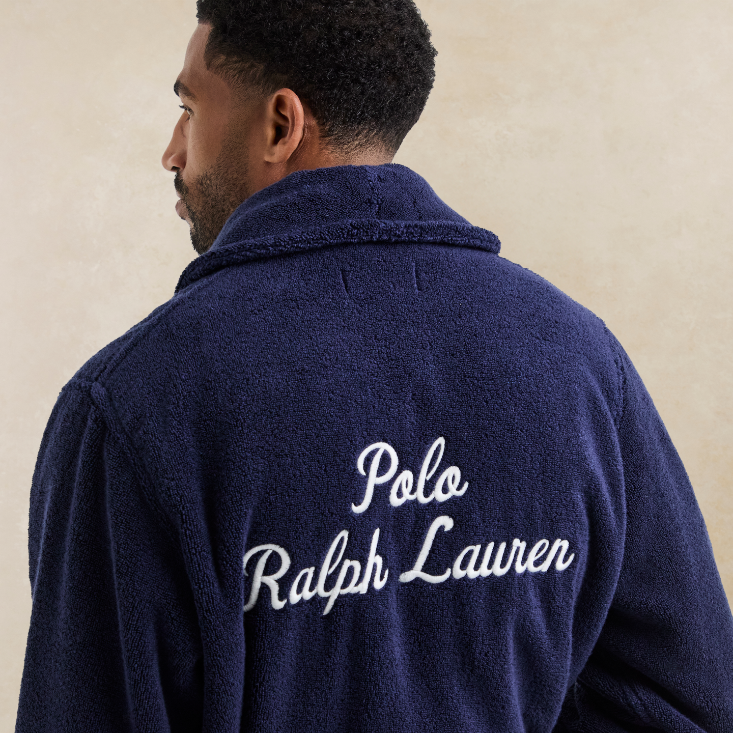 Model wearing a blue dressing gown with Polo Ralph Lauren written on the back