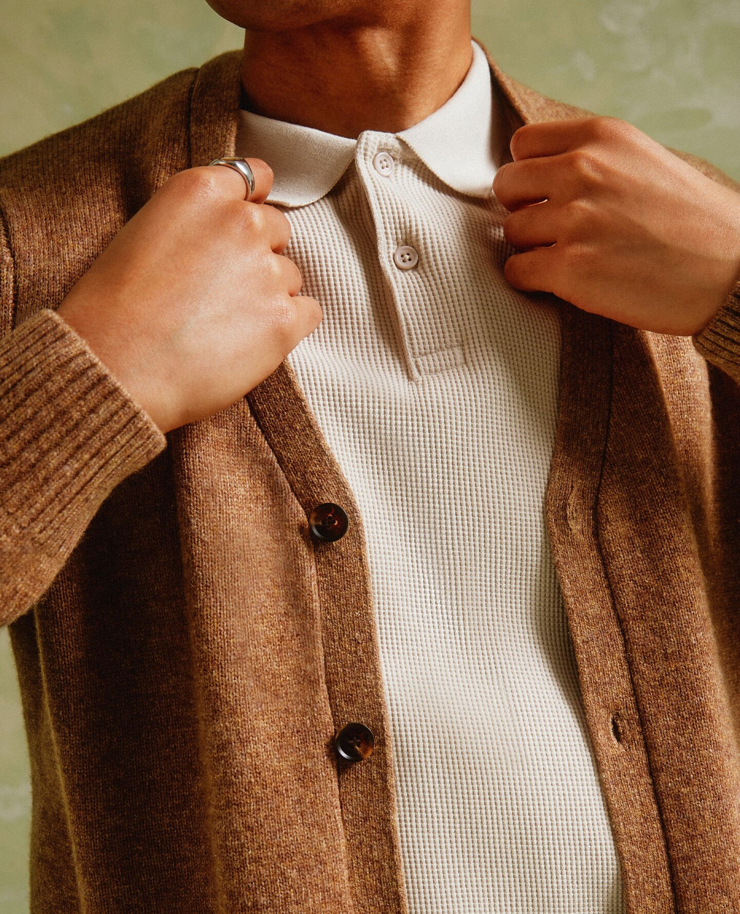 A man wearing a sand coloured cardigan