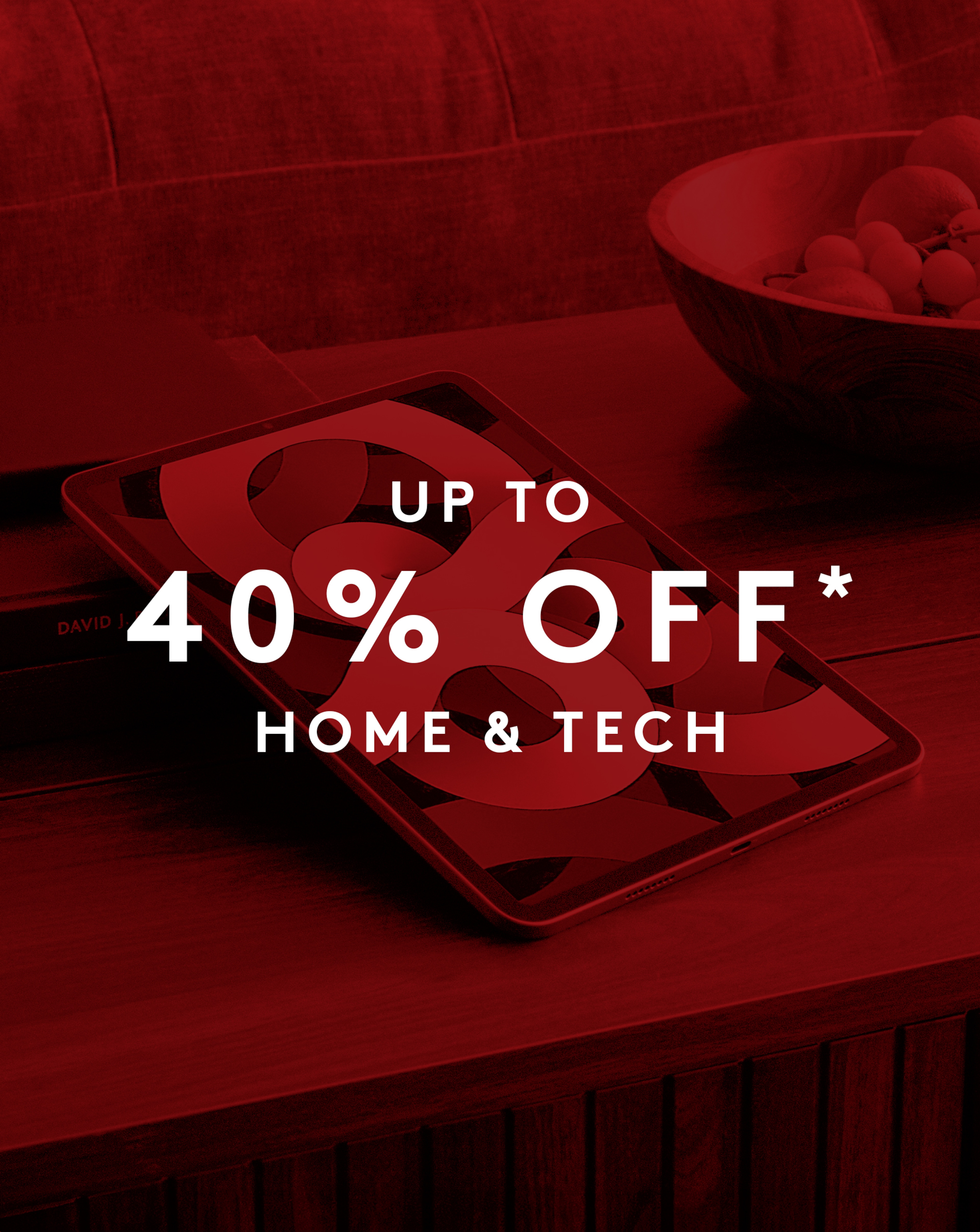 Up to 40% off* Home & Tech Apple iPad pictured on a coffe etable with fruit.