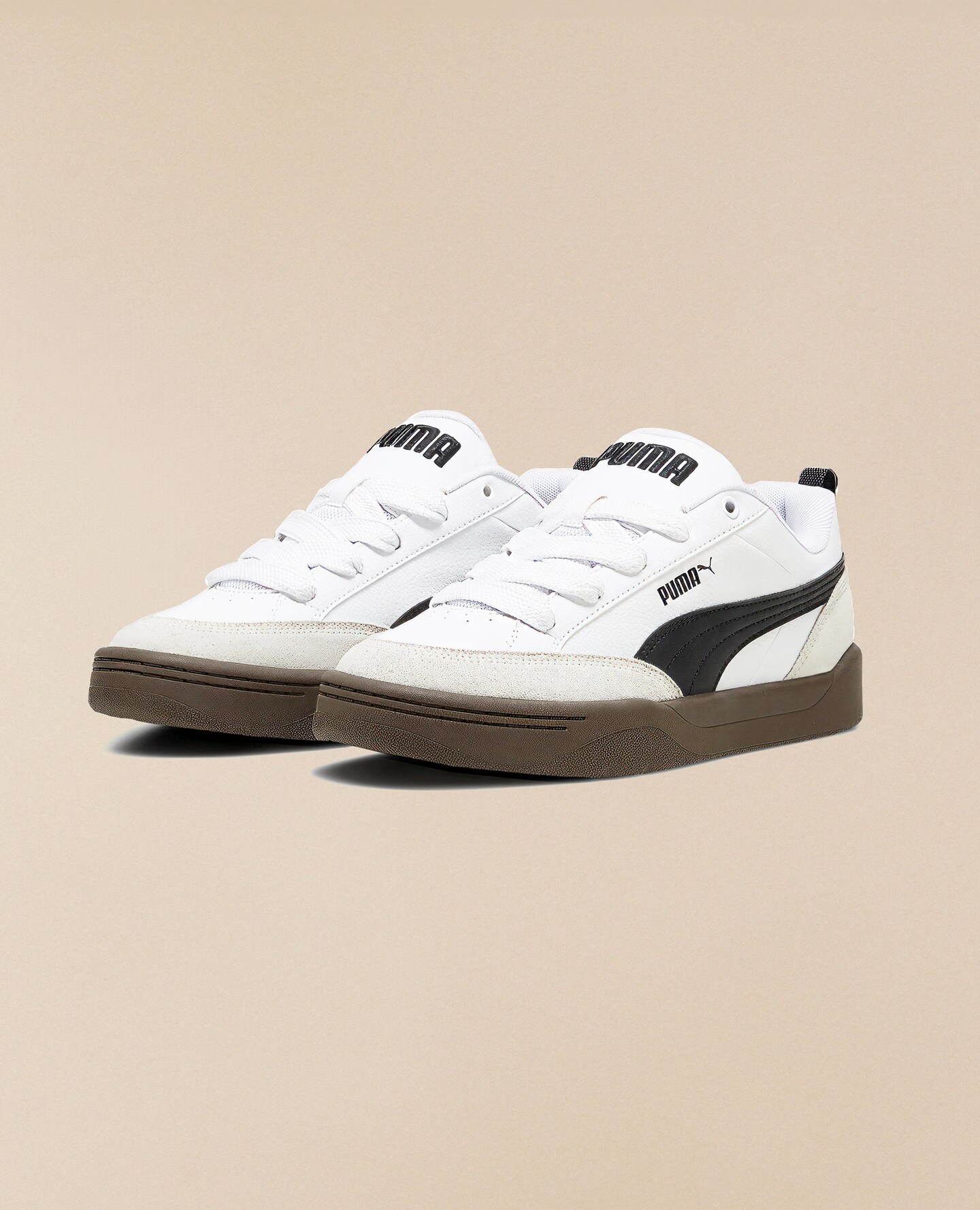 A pair of white Puma trainers