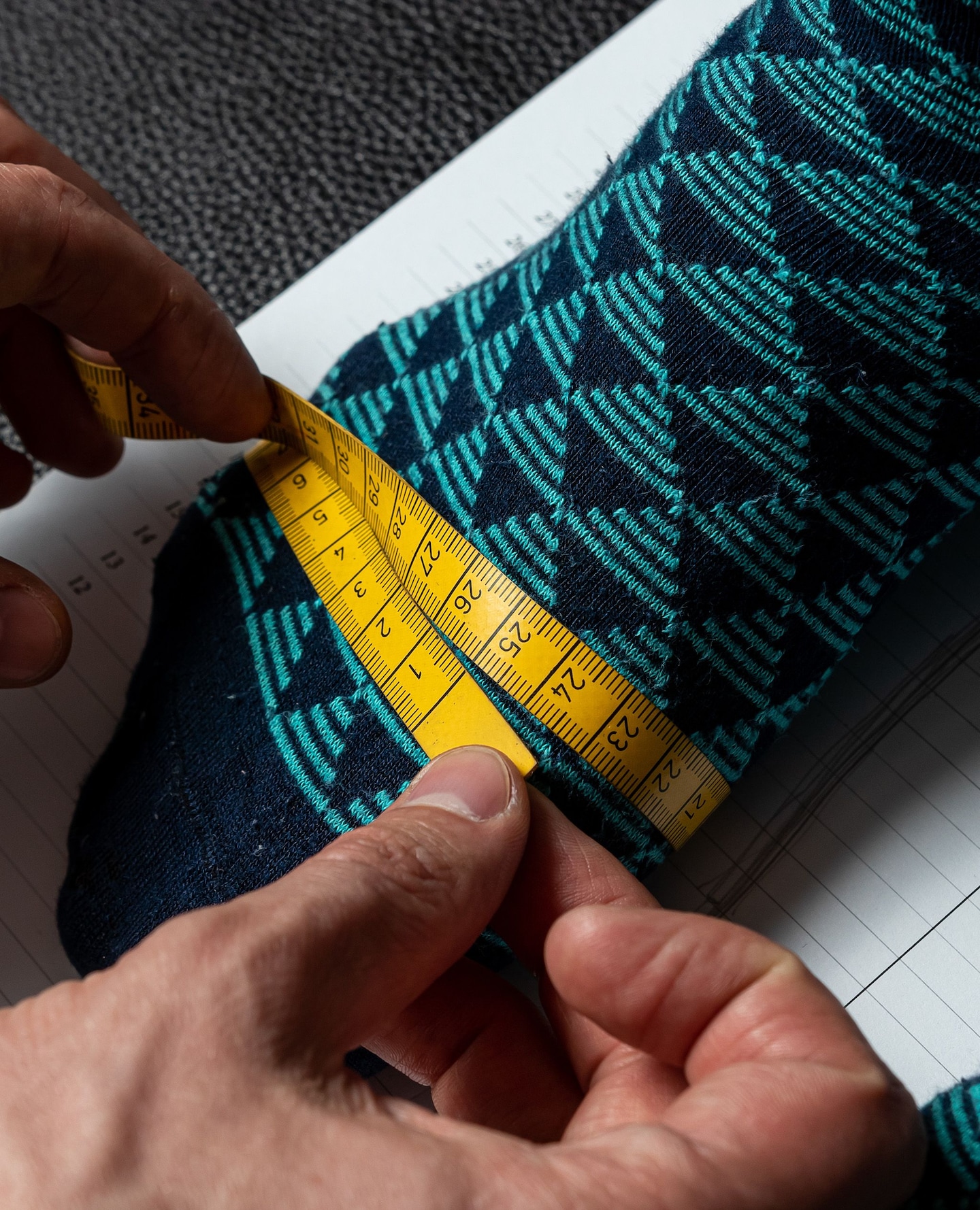 Close up on foot with a tape measured around the forefoot