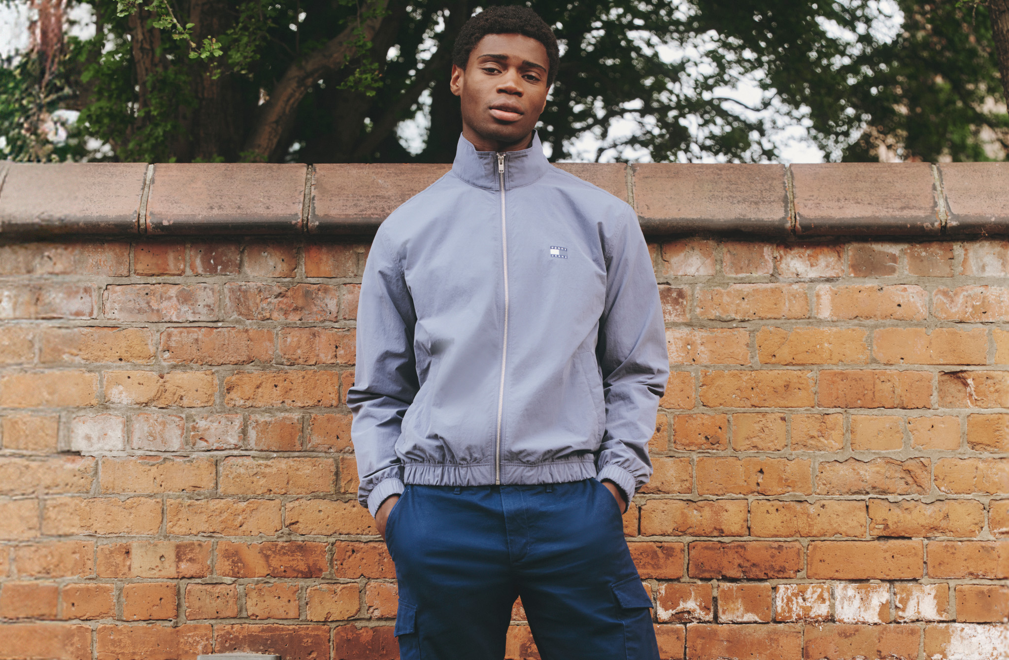 Model wearing a grey Tommy Hilfiger jacket