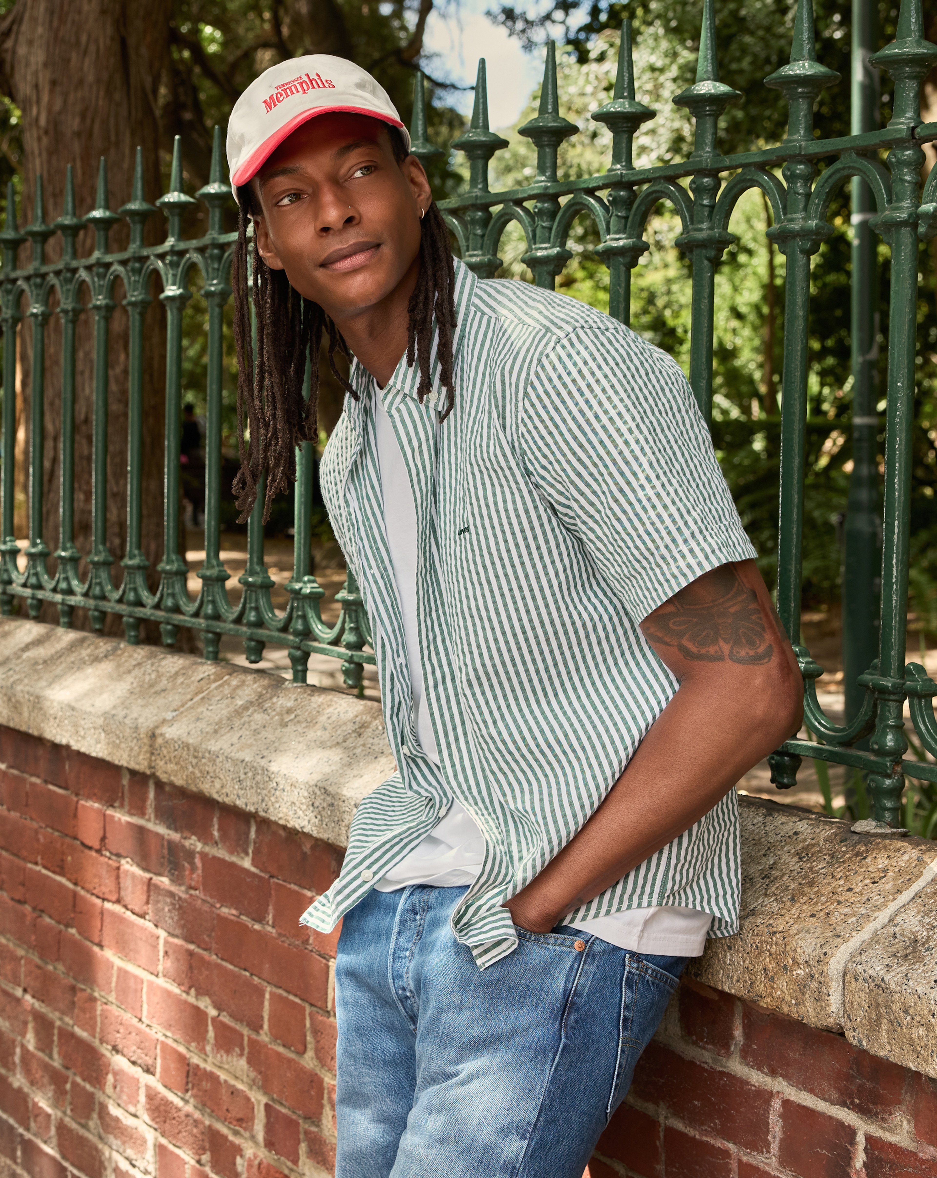 Model wears Levi's Short Sleeve Authentic Button Down Stripe Shirt - Green with cap