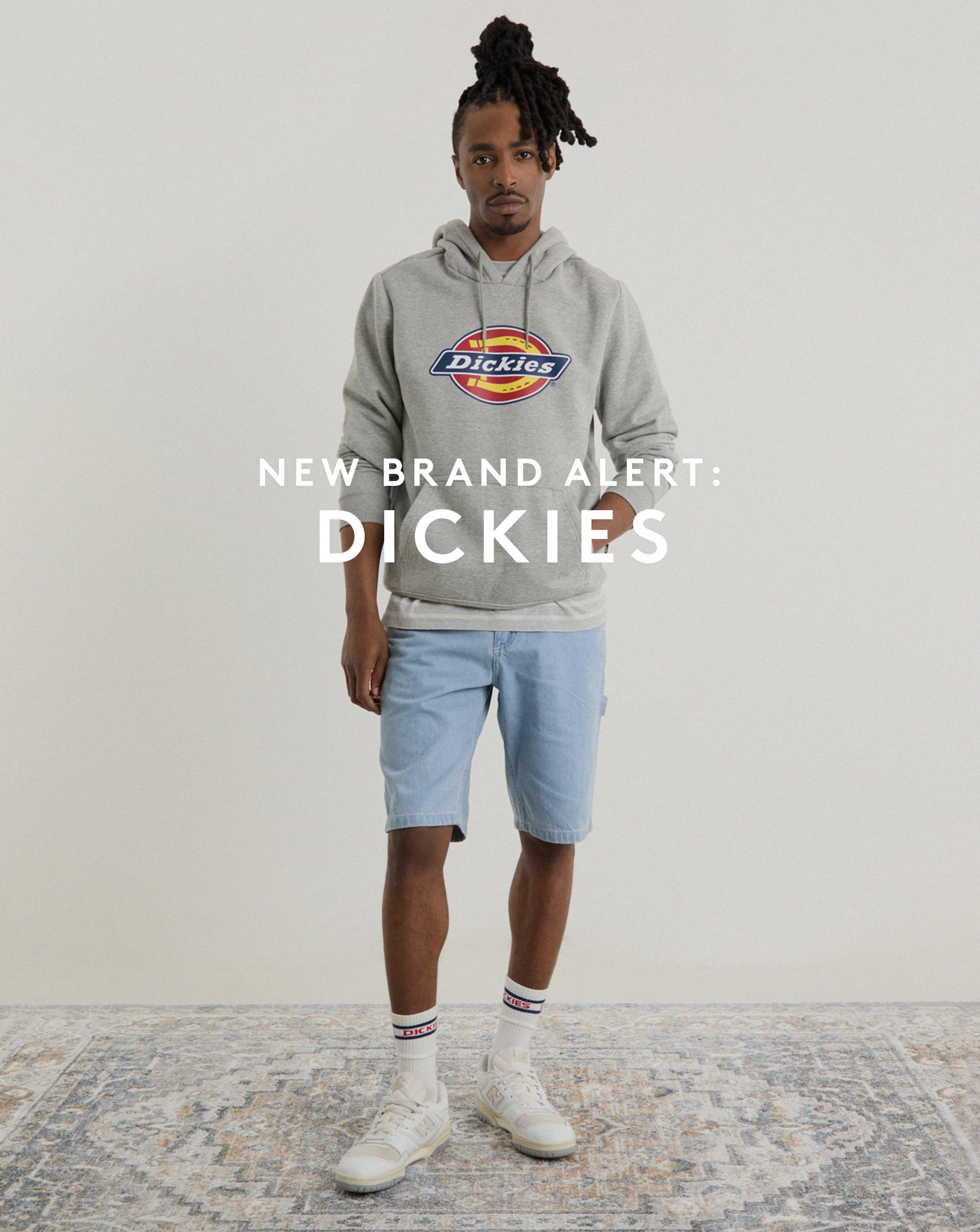 Model wearing Dickies hoodie and blue shorts