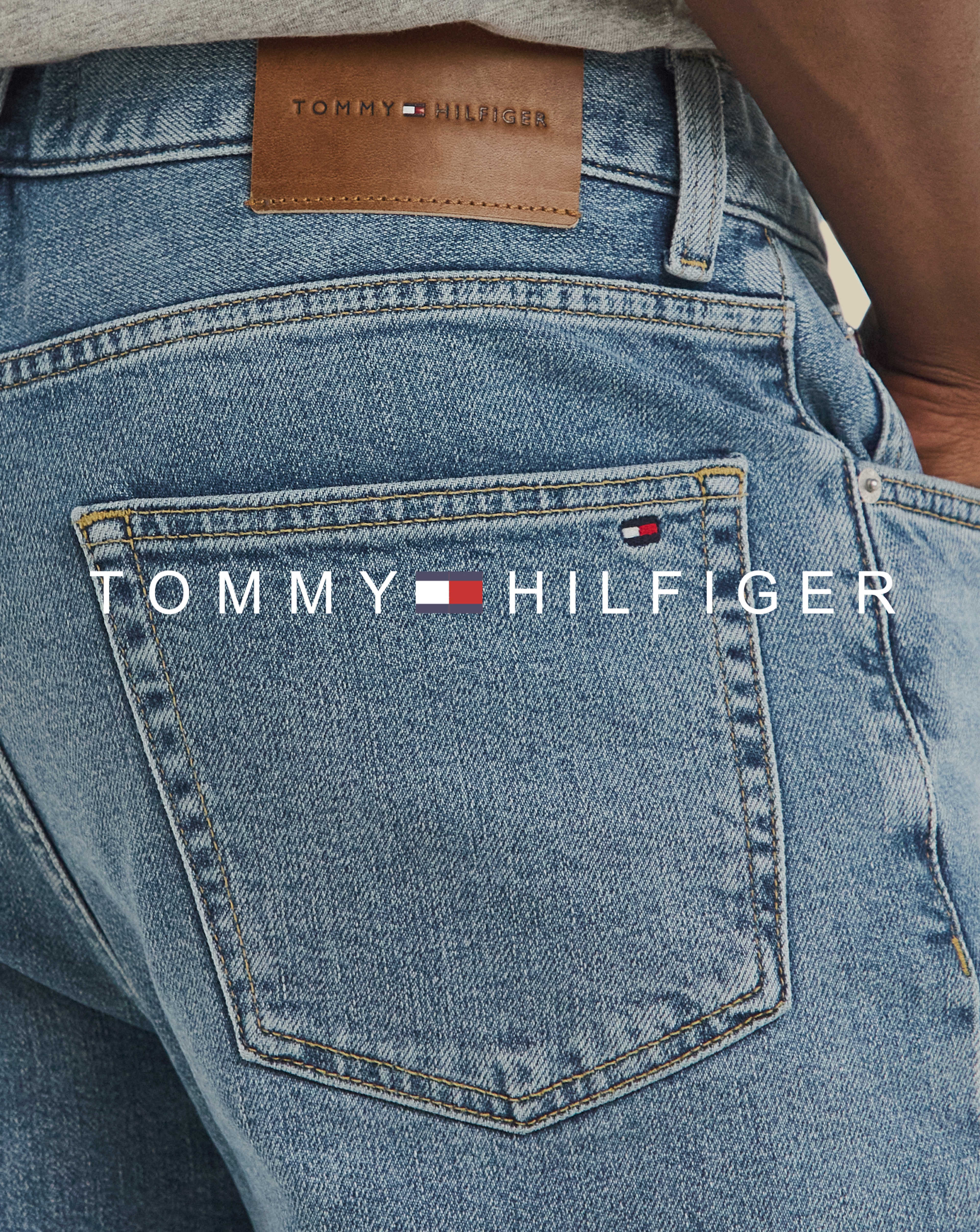 Tommy Hilfiger. Model wears Tommy Hilfiger Madison Straight Fit Denton Jean - Mid Wash