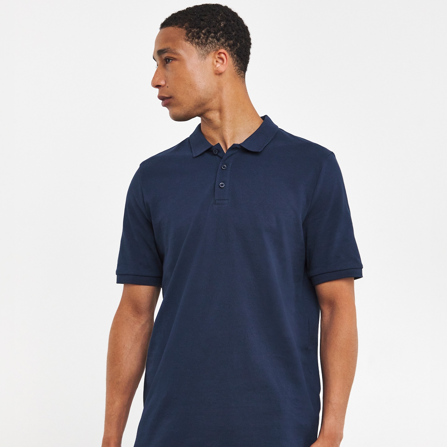 Model wearing navy polo shirt